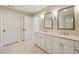 Spacious bathroom boasts a double vanity with marble countertops and stylish fixtures at 2700 Paces Ferry Se Rd # 202, Atlanta, GA 30339