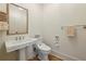 Clean and simple half bathroom with pedestal sink, toilet and stylish towel rack at 2700 Paces Ferry Se Rd # 202, Atlanta, GA 30339