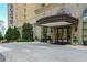 Elegant building entrance, featuring a covered entryway, manicured landscaping, and architectural details for a grand arrival at 2700 Paces Ferry Se Rd # 202, Atlanta, GA 30339