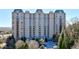 Elegant condominium building with beautiful landscaping and a circular driveway at 2700 Paces Ferry Se Rd # 202, Atlanta, GA 30339