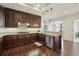 A well-designed kitchen featuring granite counters, stainless appliances, and dark wood cabinetry at 2700 Paces Ferry Se Rd # 202, Atlanta, GA 30339