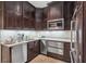 This kitchen features stainless steel appliances, granite countertops, and dark wood cabinets at 2700 Paces Ferry Se Rd # 202, Atlanta, GA 30339