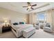 Spacious main bedroom with neutral colors, a large bed, and comfortable seating by the window at 2700 Paces Ferry Se Rd # 202, Atlanta, GA 30339