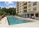Relaxing pool area with lounge chairs, umbrellas, and well-maintained grounds adjacent to the building's architecture at 2700 Paces Ferry Se Rd # 202, Atlanta, GA 30339