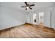 Bedroom with wood floors, ceiling fan, and views into bathroom and closet at 3142 Reeves Se St, Smyrna, GA 30080