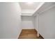 Walk-in closet with built-in shelving and wood flooring at 3142 Reeves Se St, Smyrna, GA 30080