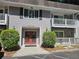 Condominium building with gray siding and red double-door entrance at 3142 Reeves Se St, Smyrna, GA 30080