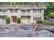 Condominium with gray siding, black shutters, balconies, and parking at 3142 Reeves Se St, Smyrna, GA 30080
