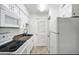 Galley kitchen featuring white appliances, granite countertops and tile floors at 3142 Reeves Se St, Smyrna, GA 30080