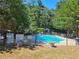 Community pool area surrounded by a black metal fence with lush greenery in the background at 3142 Reeves Se St, Smyrna, GA 30080