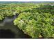 Stunning aerial view of a property surrounded by lush greenery and a serene lake at 413 Sassafras Rd, Roswell, GA 30076