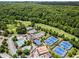 Gorgeous aerial view showcasing community amenities: pool, tennis courts, and golf course at 413 Sassafras Rd, Roswell, GA 30076