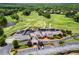 Overhead view of a country club featuring a clubhouse, golf course, and parking lot at 413 Sassafras Rd, Roswell, GA 30076
