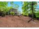 Beautiful backyard featuring a screened porch, a deck, and lush, mature trees at 413 Sassafras Rd, Roswell, GA 30076