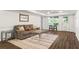 Finished basement area with a cozy sofa, decorative rug, and a walkout to the outdoors at 413 Sassafras Rd, Roswell, GA 30076