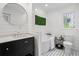 Bright bathroom with soaker tub, black and white tile flooring, and modern fixtures at 413 Sassafras Rd, Roswell, GA 30076