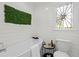 Stylish bathroom featuring a modern tub, stained glass window, and decorative wall art at 413 Sassafras Rd, Roswell, GA 30076