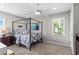Modern bedroom with a four-poster bed, neutral walls and carpet, bright natural light, and dark wood furnishings at 413 Sassafras Rd, Roswell, GA 30076