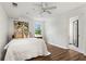 Basement bedroom with ensuite bathroom, light walls, hardwood flooring and a window with bright sunlight at 413 Sassafras Rd, Roswell, GA 30076