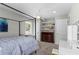 Well-lit bedroom showcasing a four-poster bed, a built-in vanity, and shelving with a view to the outside at 413 Sassafras Rd, Roswell, GA 30076