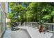Inviting outdoor deck area with a comfortable hanging chair and beautiful green scenery at 413 Sassafras Rd, Roswell, GA 30076