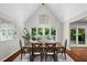 Dining area with vaulted ceiling, skylight, hardwood floors, and sliding glass doors to deck at 413 Sassafras Rd, Roswell, GA 30076