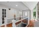 Foyer with hardwood floors, stone fireplace, and decorative glass front door providing a warm welcome at 413 Sassafras Rd, Roswell, GA 30076