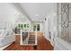 Inviting foyer with gleaming hardwood floors, a skylight, and decorative glass front door at 413 Sassafras Rd, Roswell, GA 30076