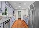 Updated kitchen with granite countertops, stainless steel appliances, and hardwood floors at 413 Sassafras Rd, Roswell, GA 30076