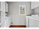 Bright laundry room with washer, dryer, and convenient storage cabinets at 413 Sassafras Rd, Roswell, GA 30076