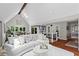 Open-concept living room boasting vaulted ceilings, hardwood floors, and comfortable seating area at 413 Sassafras Rd, Roswell, GA 30076