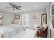 Spacious main bedroom with ample closet space, a ceiling fan, and large windows at 413 Sassafras Rd, Roswell, GA 30076