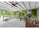 Charming screened porch with wicker furniture and plants, creating a relaxing outdoor living space at 413 Sassafras Rd, Roswell, GA 30076