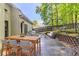 Outdoor patio with dining and seating areas, and a manicured backyard at 5335 Lexington View Pl, Sugar Hill, GA 30518