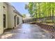 Outdoor patio and fenced backyard with mature trees at 5335 Lexington View Pl, Sugar Hill, GA 30518