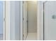 Hallway leading to bath with shower and tile floors at 5335 Lexington View Pl, Sugar Hill, GA 30518
