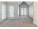 Spacious bedroom with plush carpeting, many windows and vaulted ceilings at 5335 Lexington View Pl, Sugar Hill, GA 30518