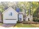 Two-story home featuring an attached garage and mature trees on a lush, green lawn at 5335 Lexington View Pl, Sugar Hill, GA 30518