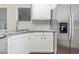 Kitchen showcases stainless steel refrigerator, granite counters and white cabinetry at 5335 Lexington View Pl, Sugar Hill, GA 30518