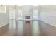Open living room with fireplace, natural light, and wood-look tile flooring at 5335 Lexington View Pl, Sugar Hill, GA 30518