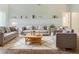 Comfortable living room featuring neutral tones, plush furniture, and bright natural light at 5335 Lexington View Pl, Sugar Hill, GA 30518