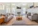 Cozy living room featuring plush furniture, a fireplace and natural light at 5335 Lexington View Pl, Sugar Hill, GA 30518