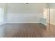 Living room features detailed wall trim, bright natural light, and hardwood-look flooring at 5335 Lexington View Pl, Sugar Hill, GA 30518