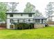 Spacious backyard featuring a deck, lush green grass, and mature trees at 5380 Northchester Ct, Dunwoody, GA 30338