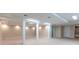 Large finished basement area with support columns, tile flooring, and recessed lights at 5380 Northchester Ct, Dunwoody, GA 30338