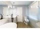 Well lit bathroom with a double vanity, soaking tub, toilet, and glass shower at 5380 Northchester Ct, Dunwoody, GA 30338