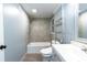 Modern bathroom with tiled shower over tub, gray vanity, and coordinated fixtures at 5380 Northchester Ct, Dunwoody, GA 30338