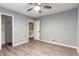 Large bedroom with wood floors, closet, and open door to hallway at 5380 Northchester Ct, Dunwoody, GA 30338