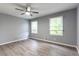 Bright bedroom with wood floors, two windows, and neutral paint at 5380 Northchester Ct, Dunwoody, GA 30338