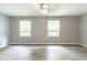 Spacious bedroom with wood floors, modern lighting, and two bright windows at 5380 Northchester Ct, Dunwoody, GA 30338